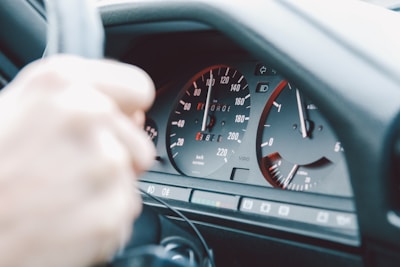 A close-up of a steering wheel and dashboard of a car.