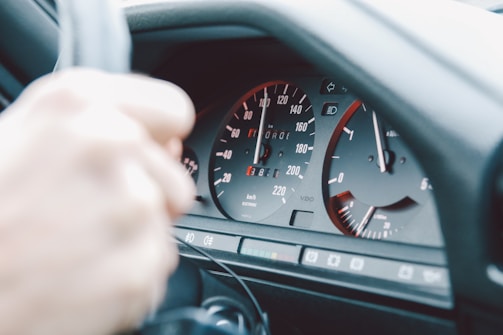 A close-up of a car's dashboard with a focus on the speedometer.