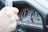 Close-up of a taxi meter and steering wheel inside a car.