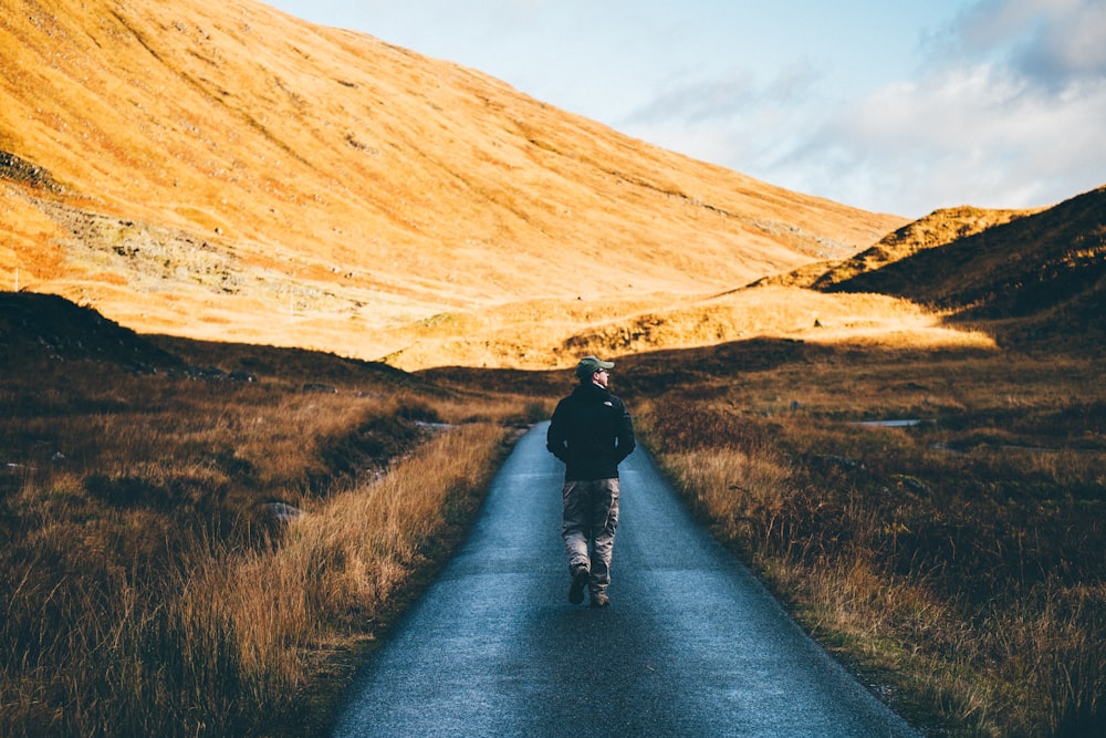 man walking on road photo