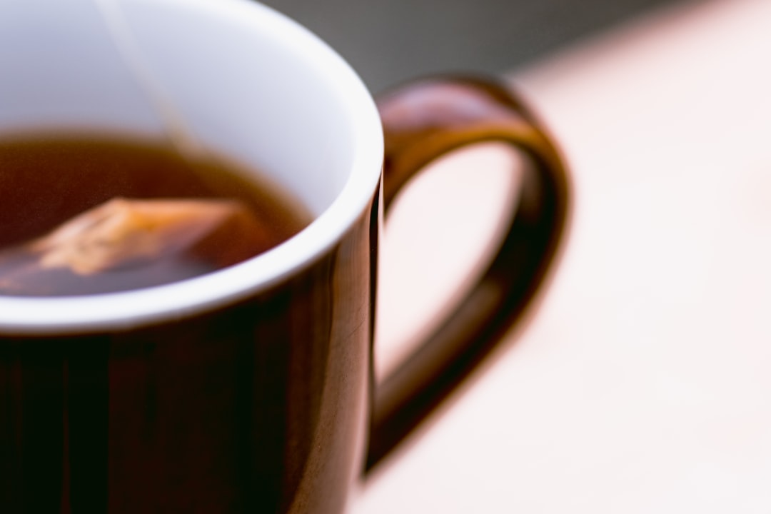 brown ceramic mug with brown liquid inside