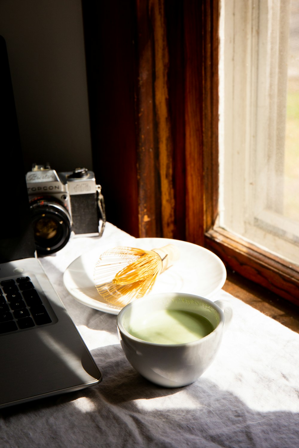 white ceramic tea cup beside white ceramic plate