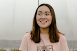 selective focus photograph of woman in pink crew-neck t-shirt