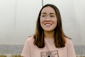 selective focus photograph of woman in pink crew-neck t-shirt