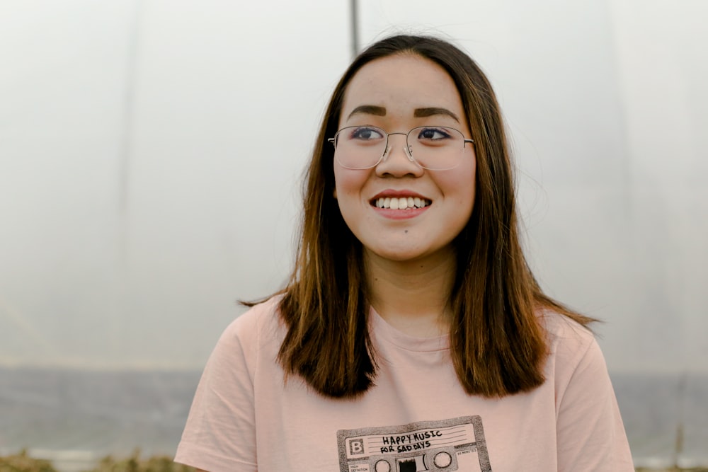 selective focus photograph of woman in pink crew-neck t-shirt