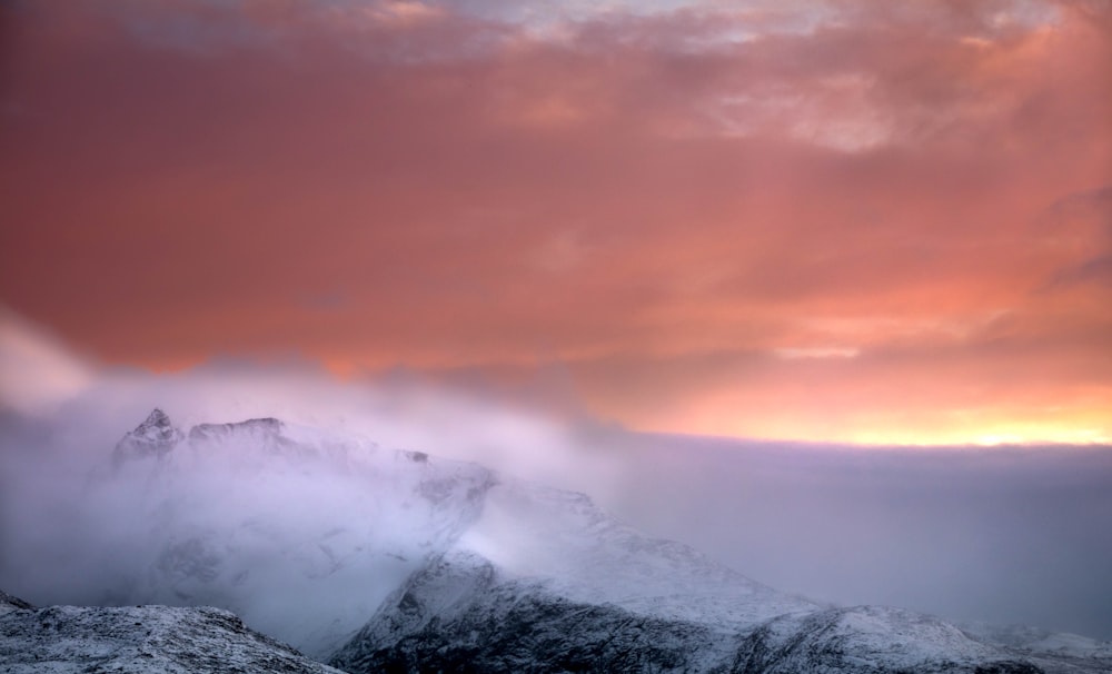 snow covered mountain during sunset