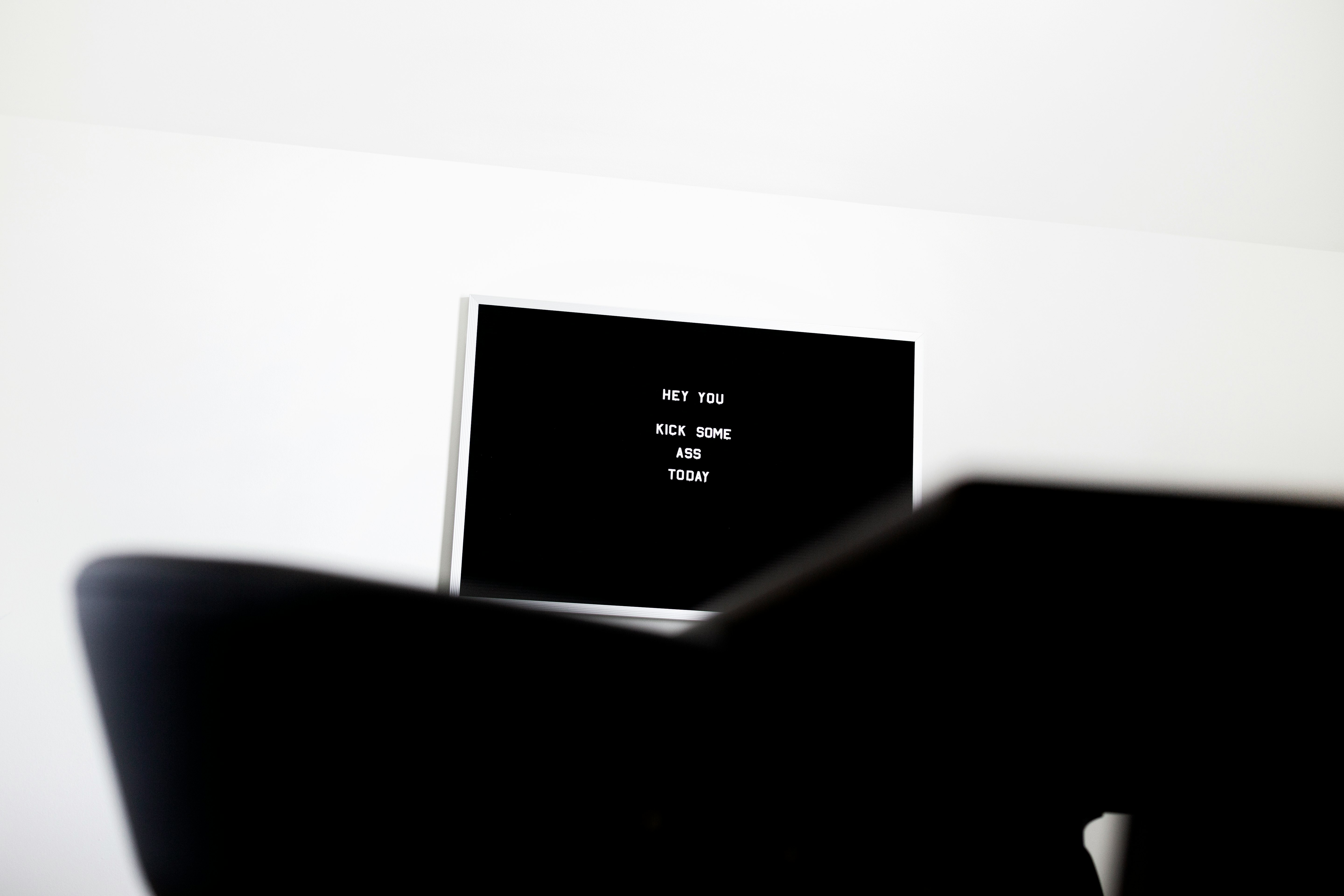 white flat screen television on white wall