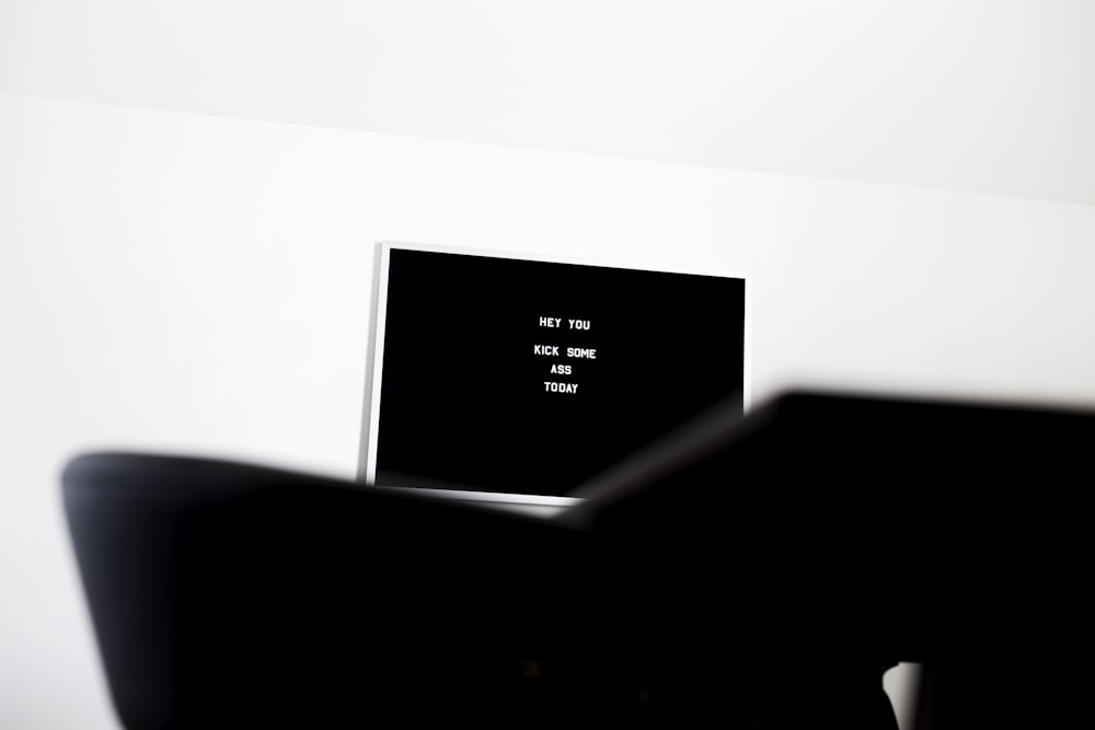 white flat screen television on white wall