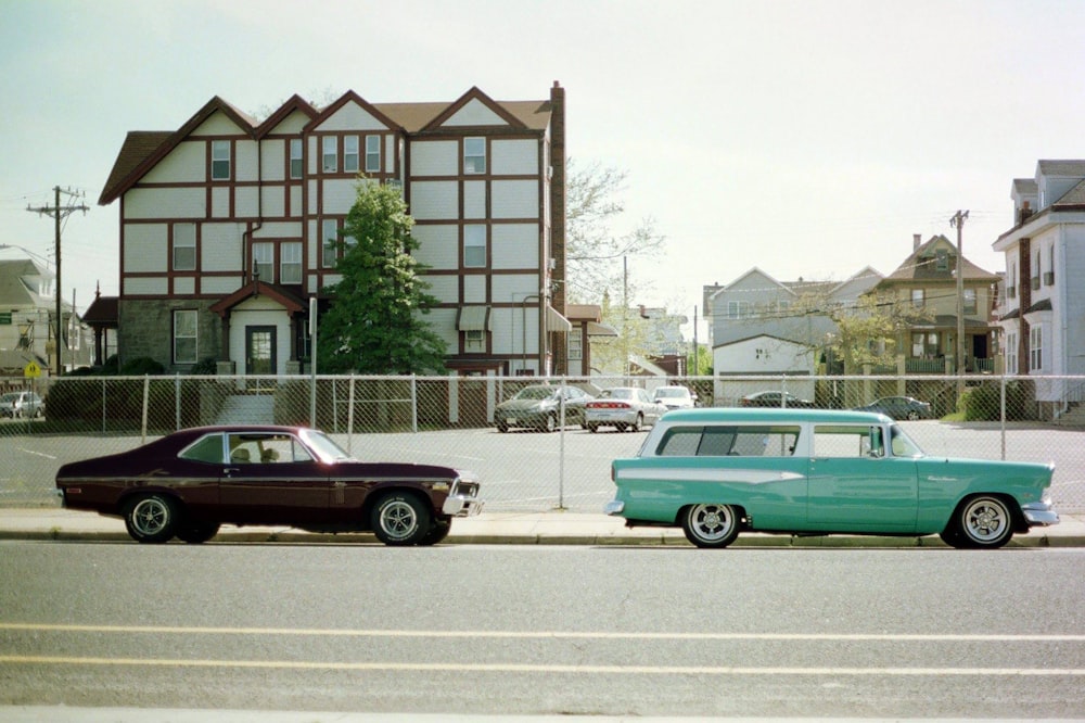 two brown and green coupes beside houses