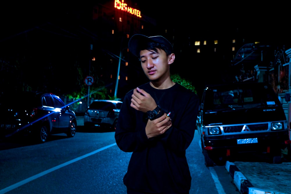 man wearing black crew-neck long-sleeved shirt