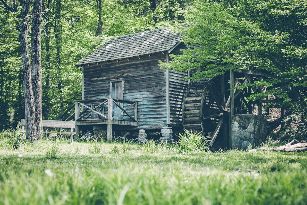 gray wooden shed with watermill