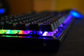 Side view of a mechanical keyboard with vibrant backlighting during gameplay.