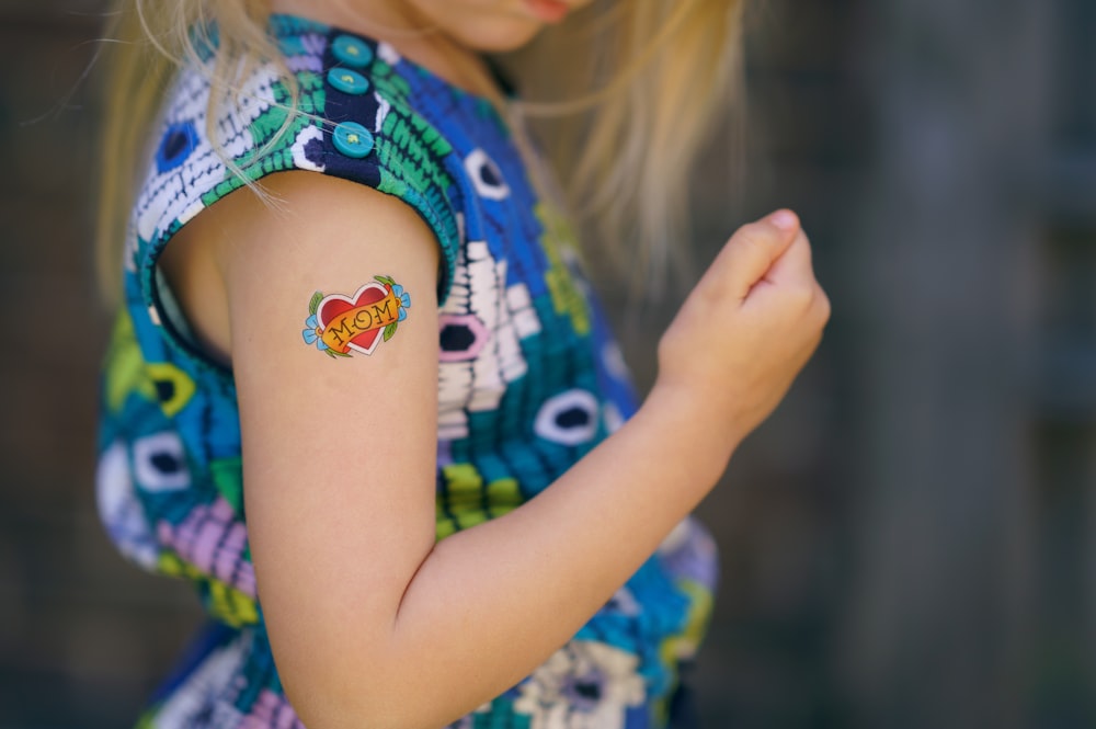 Foto di messa a fuoco selettiva della ragazza con il tatuaggio del cuore