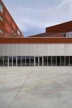 University building exterior featuring clean, modern architecture with red accents.