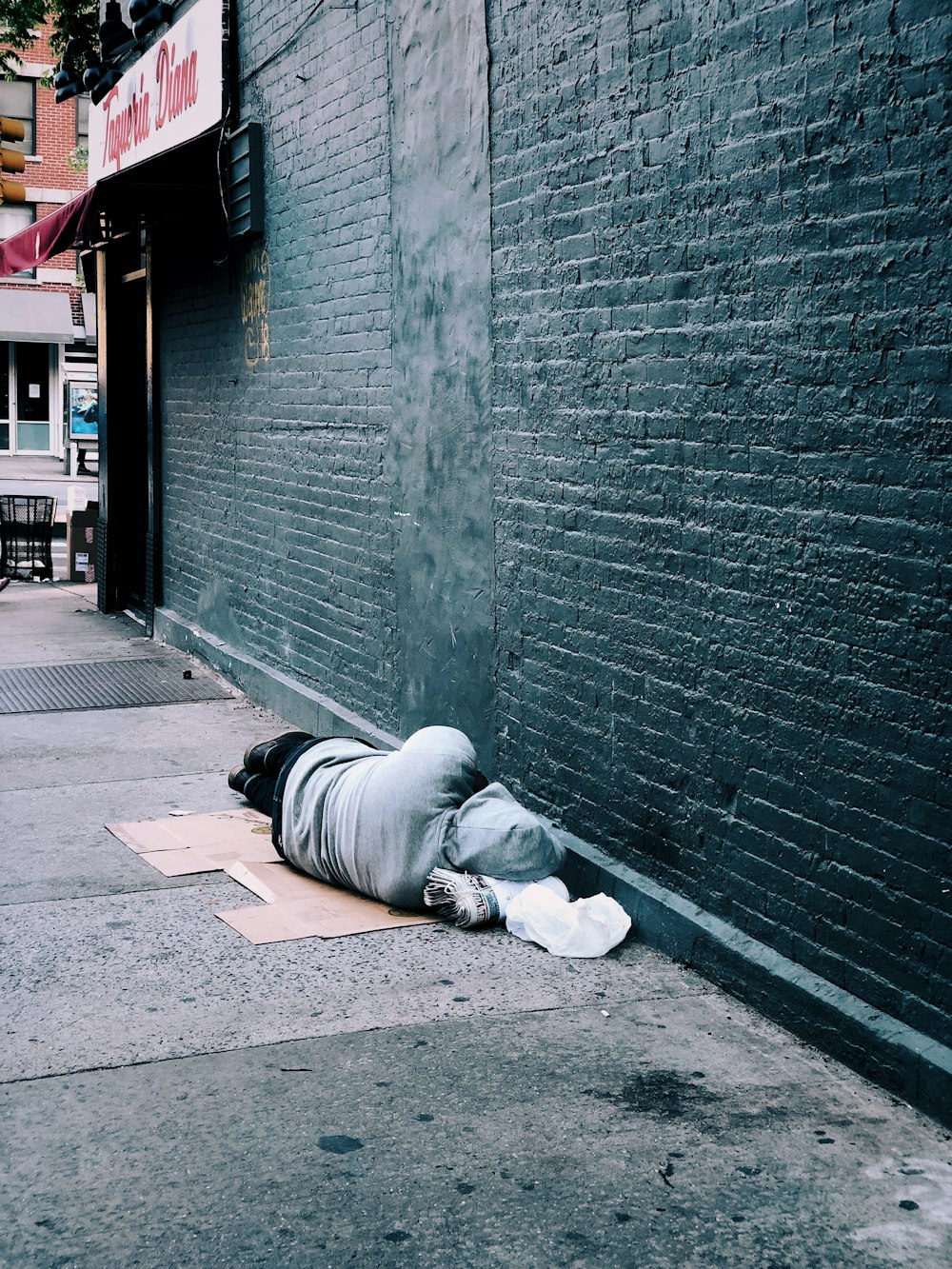 man lying on brown cardboard box