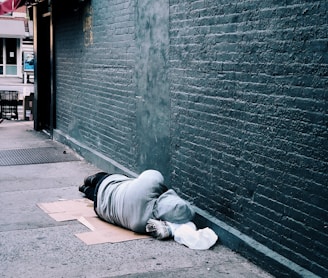 man lying on brown cardboard box