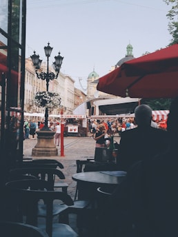 A vibrant street scene featuring a cozy café and local market stalls.