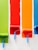 four orange, green, blue, and red paint rollers