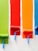 four orange, green, blue, and red paint rollers