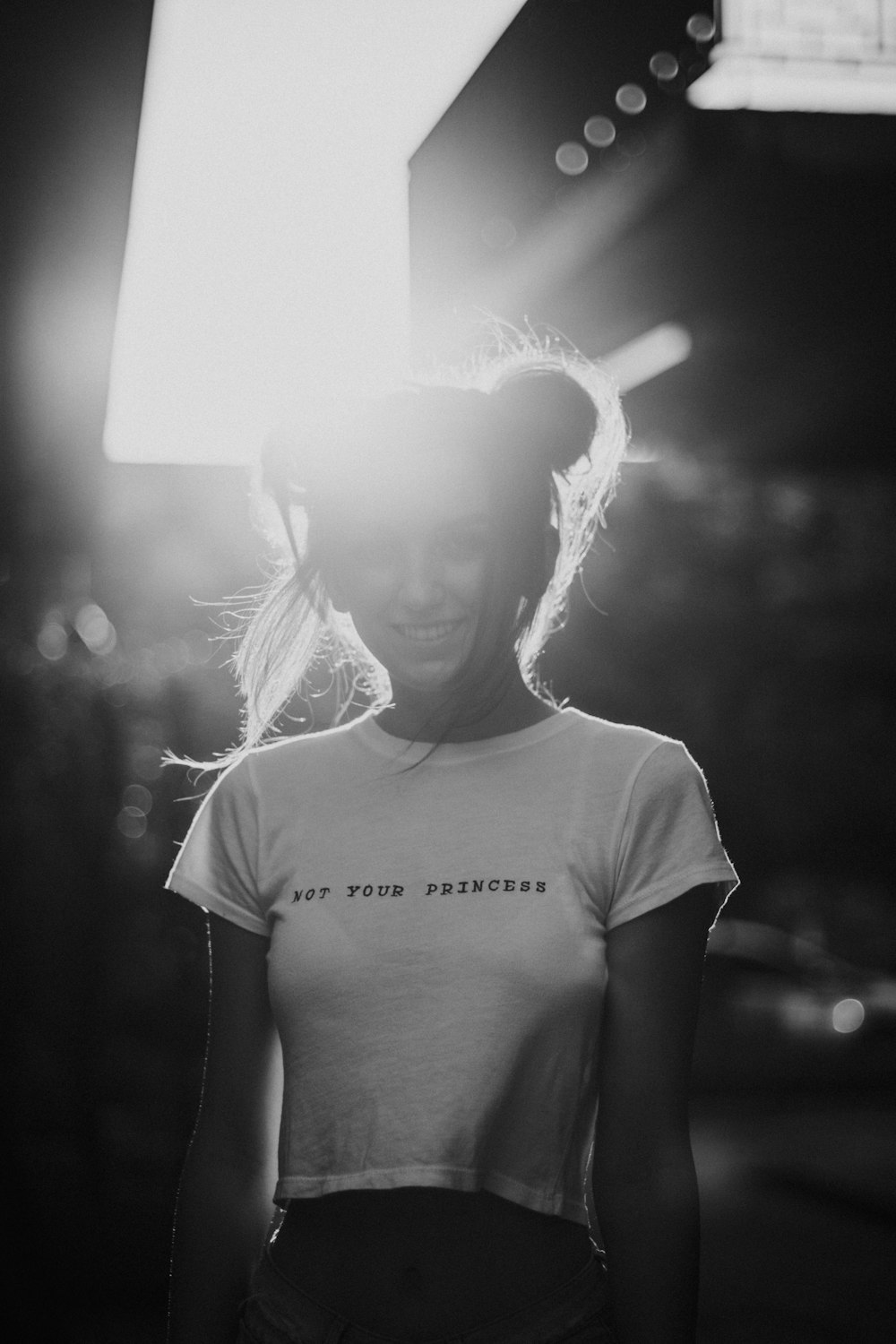 grayscale photo of woman wearing white crew-neck crop top