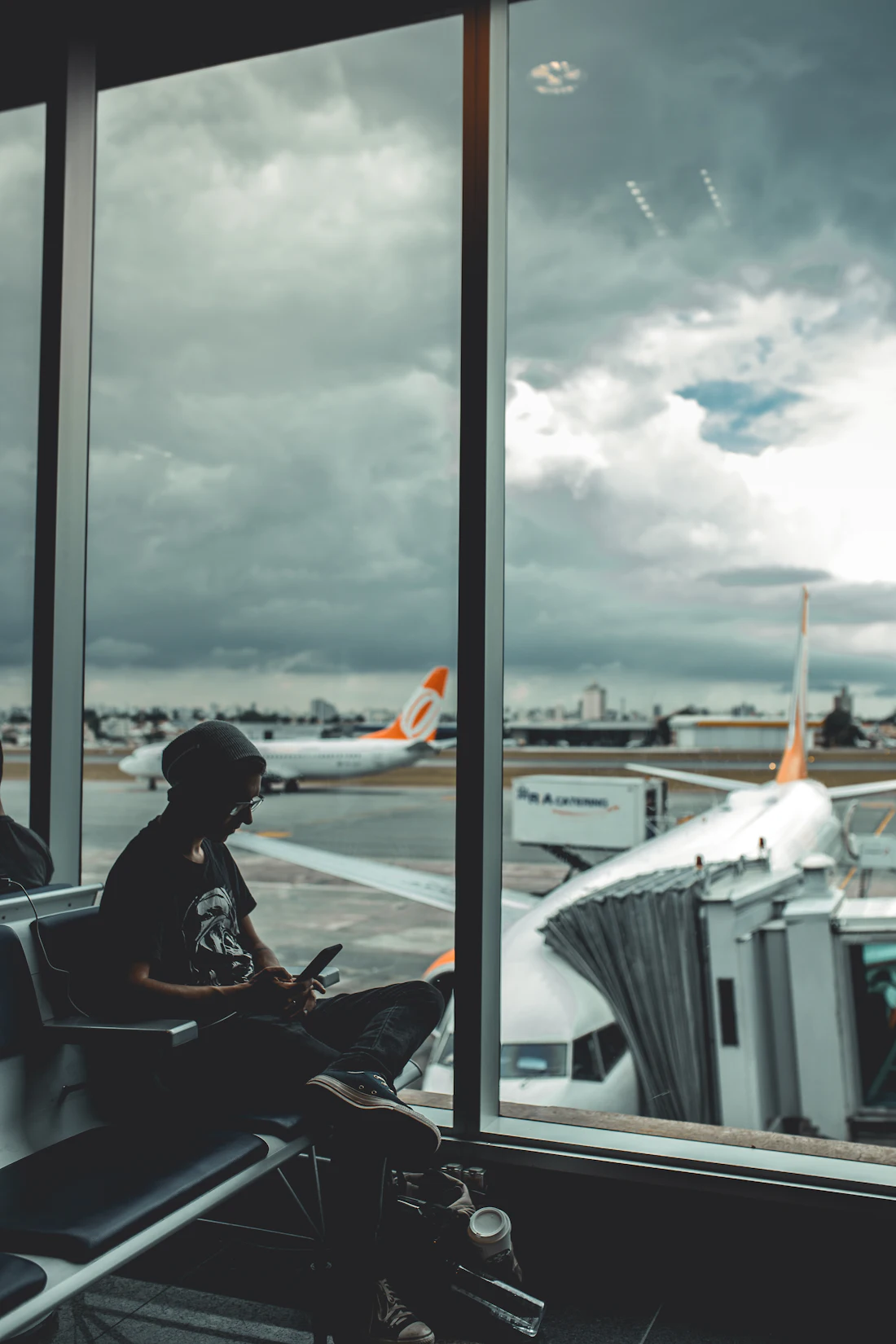 A traveller checking his phone at the airport