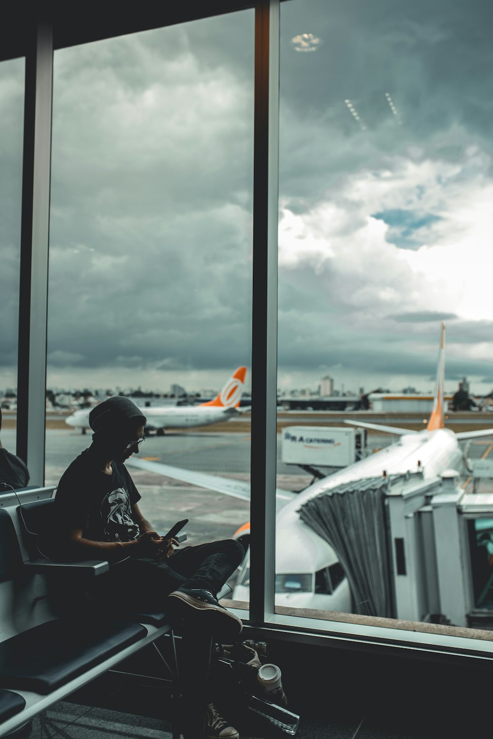 man browsing his phone in airport