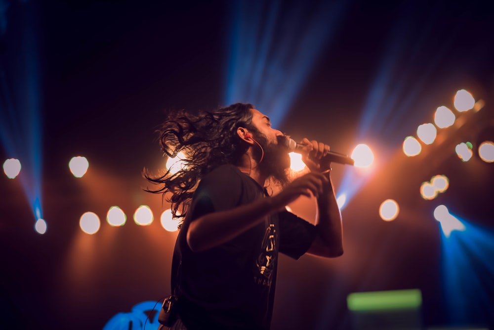 man holding microphone on stage