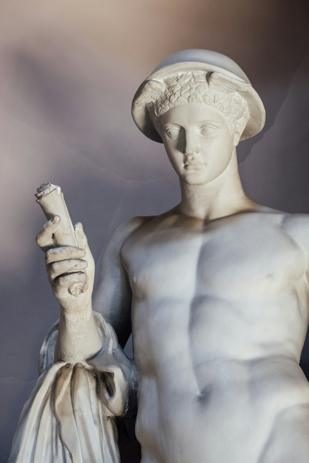 man holding pipe statue