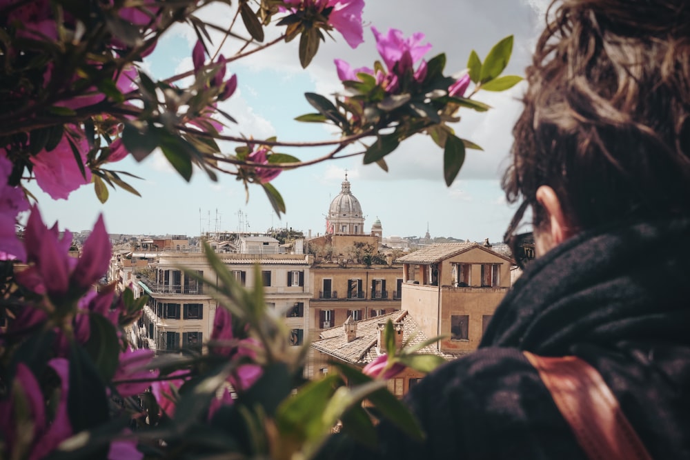 selective focus photography of man facing concrete building during dayitme