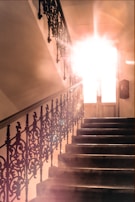 The staircase leading up to the third-floor condo, bathed in warm afternoon light.