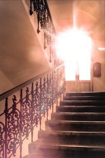The staircase leading up to the third-floor condo, bathed in warm afternoon light.