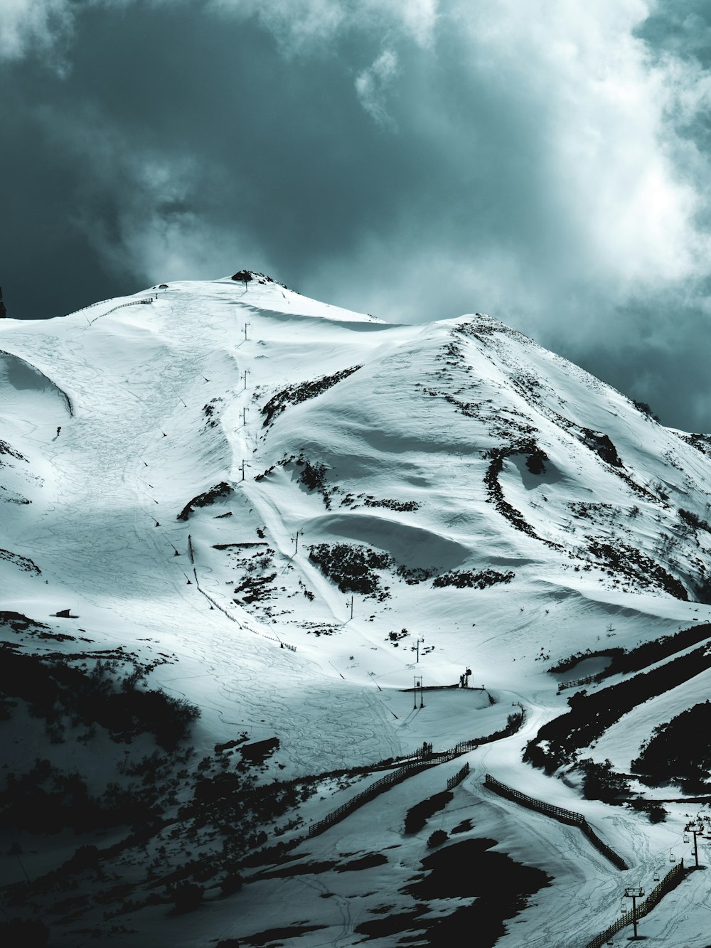 snow covered mountain under cloudy sky