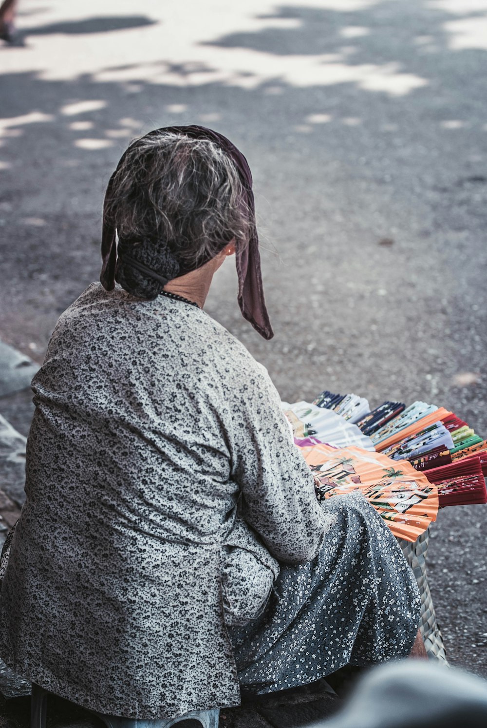 woman sitting beside road