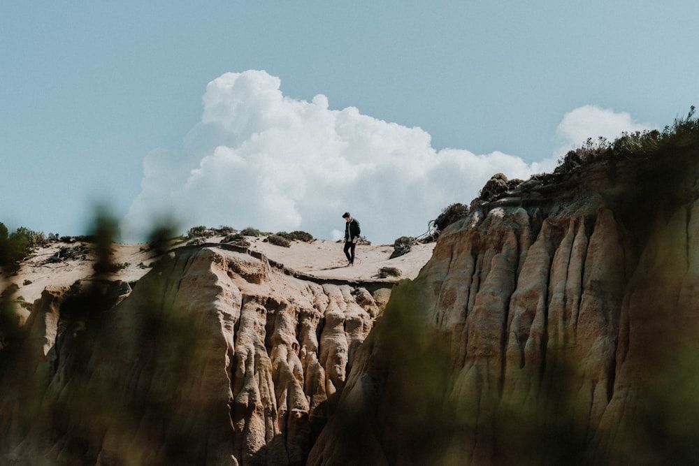 man standing on cliff