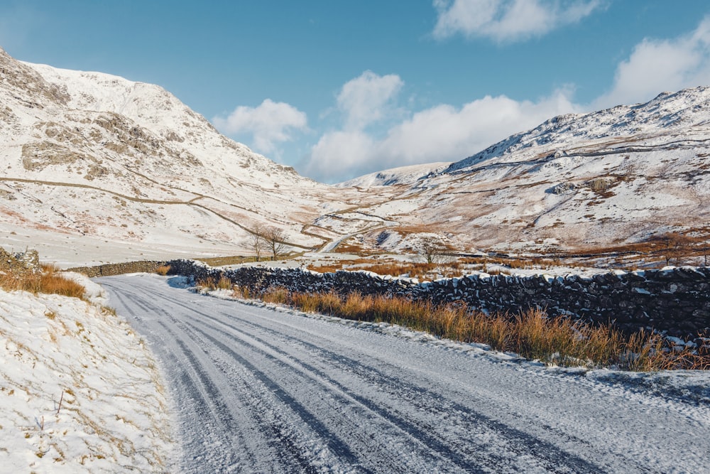 mountain near grass field and road