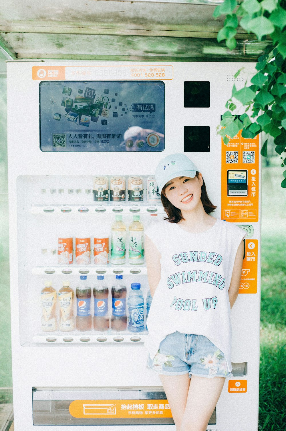 woman leaning in front of soda money operated machine