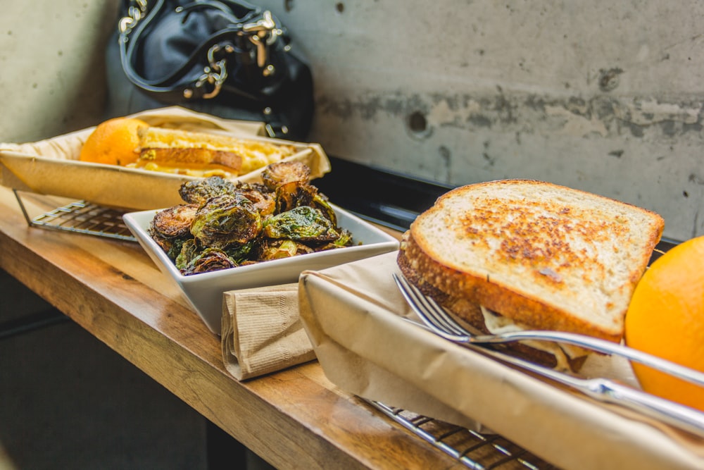 baked bread on metal basket near white wall