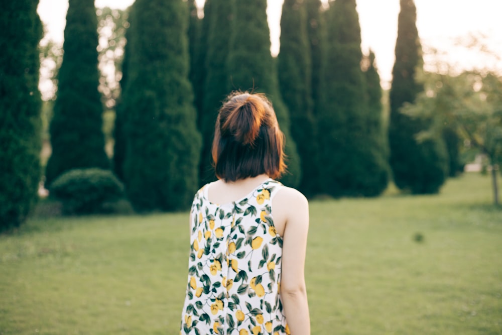 woman walking on lawn during daytime