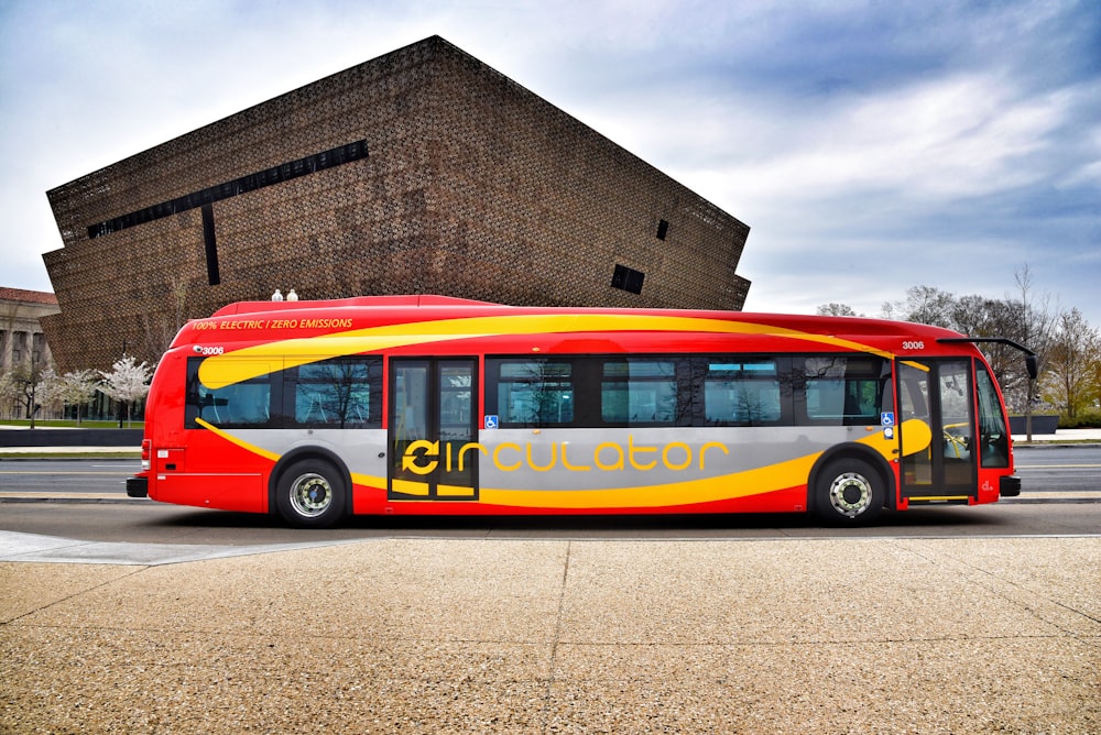 red, gray, and yellow bus