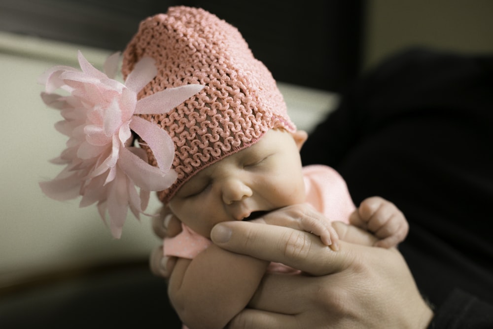 baby in pink knit cap