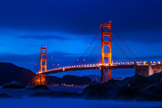 Golden Gate bridge with lights turn on in Baker Beach United States