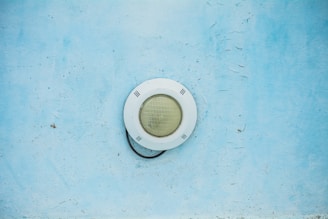 Technician installing underwater lighting system in a residential pool.