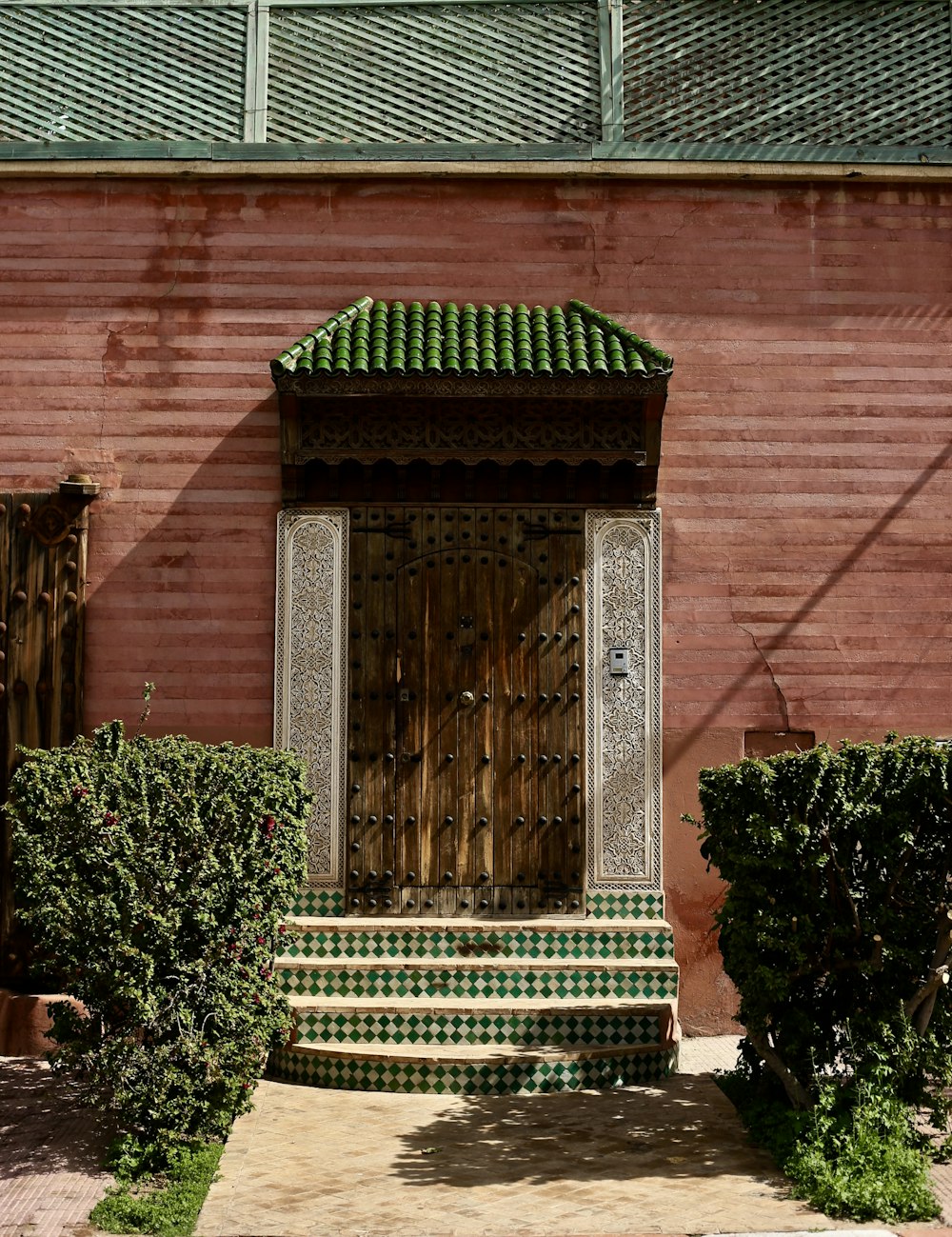 photography of pink concrete house near plants