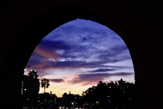 A vibrant collage showing iconic landmarks from Bali, Greece, and Morocco under a golden sunset.