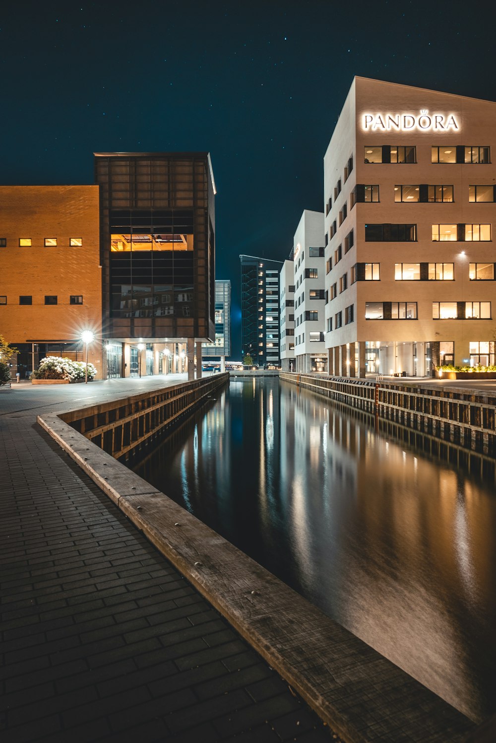 body of water between concrete buildings