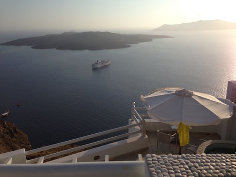 A serene ocean view with a luxurious cruise ship sailing in the distance.