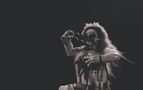 Close-up of a performer in costume delivering a dramatic monologue.