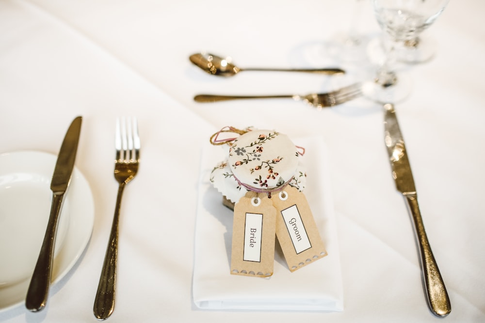 a place setting with silverware and place cards