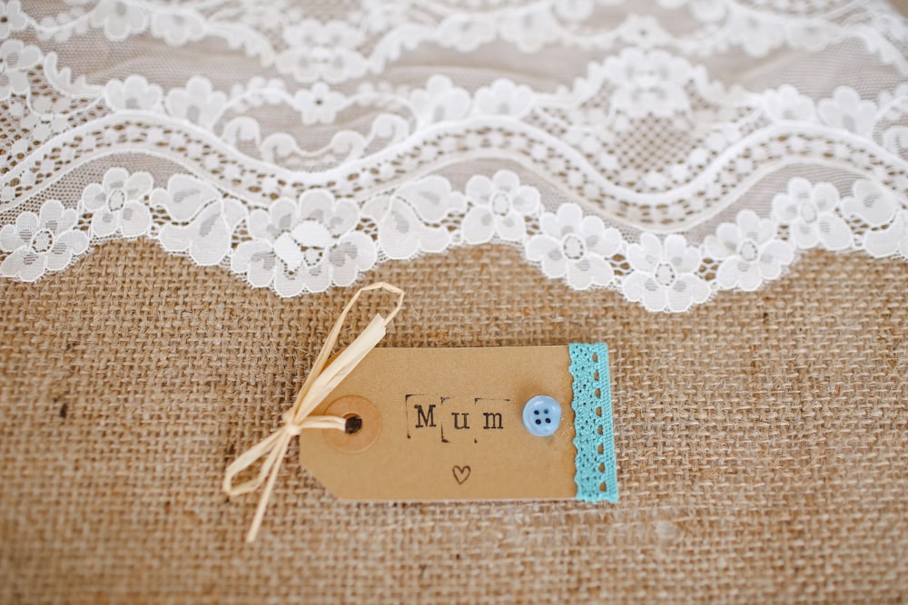 white lace cloth near mum tag
