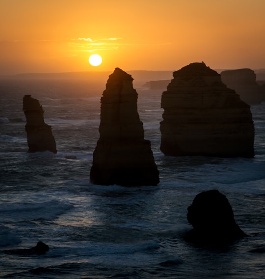 photograph of rock formation on sea during golden hour in Twelve Apostles Australia